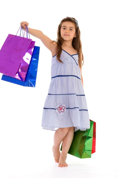 Little girl with packages — Stock Photo, Image