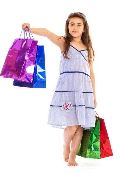 Little girl with packages — Stock Photo, Image