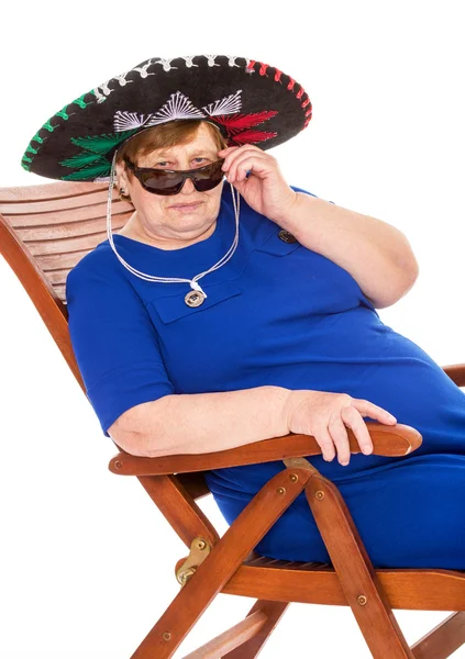 Mature woman relaxing on a lounger — Stock Photo, Image