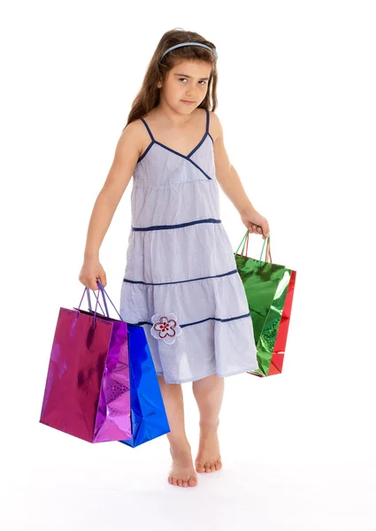 Маленькая девочка с пакетами — стоковое фото
