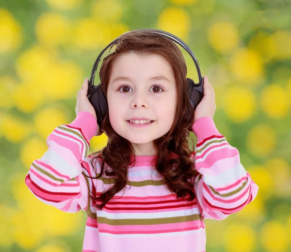 Girl with big black headphones — Stock Photo, Image