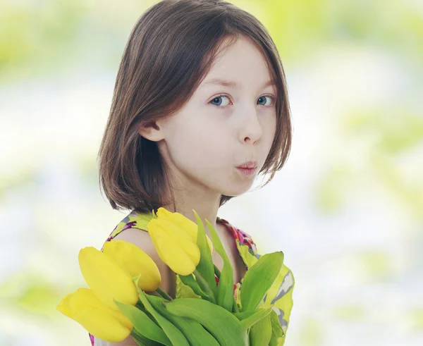 Girl with yellow tulips — Stock Photo, Image