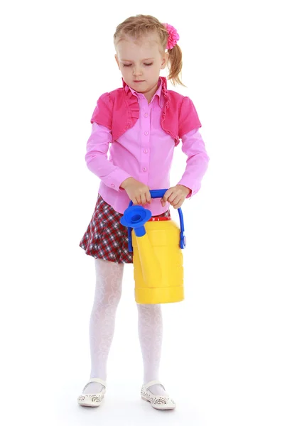 Girl holding a garden watering can. — Stock Photo, Image