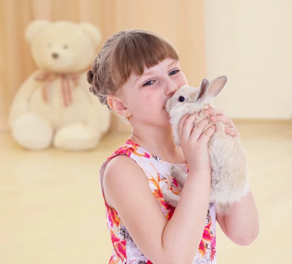 Girl kissing a rabbit. — Stock Photo, Image