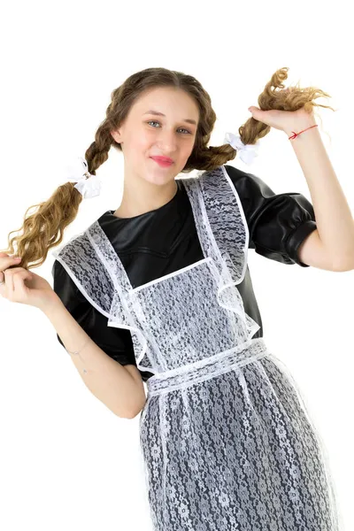 Chica estudiante alegre sosteniendo sus dos trenzas rizadas —  Fotos de Stock