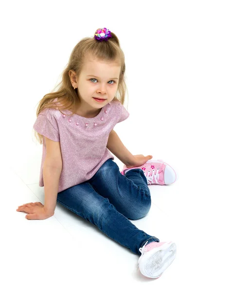 Adorable blonde little girl sitting on the floor — Stock Photo, Image