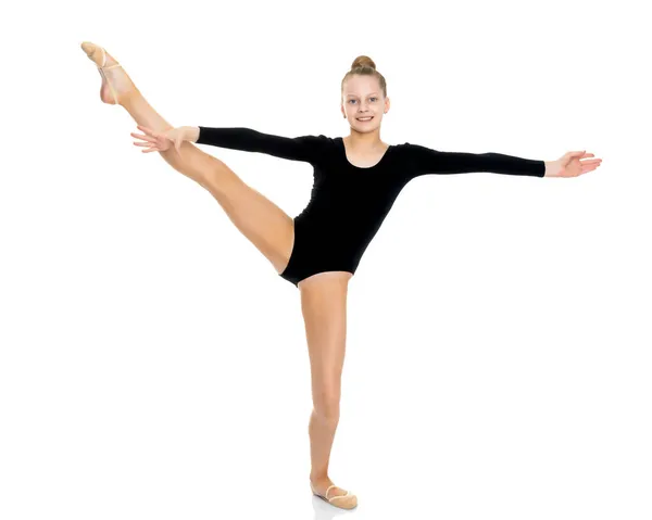 The gymnast balances on one leg. — Stock Photo, Image