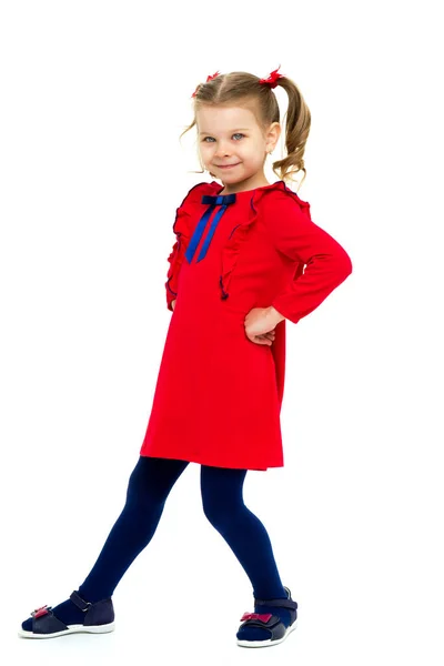 Happy little girl standing with hands on her hips — Stock Photo, Image