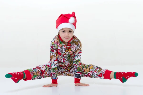 Happy little girl gymnast doing handstand and split — Stock Photo, Image