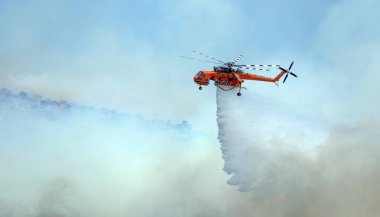 Atina, Yunanistan, 4 Haziran 2022: Atina 'nın Glyfada banliyösü yakınlarındaki Hymettus Dağı' nda bir itfaiye helikopteri faaliyet gösteriyor.