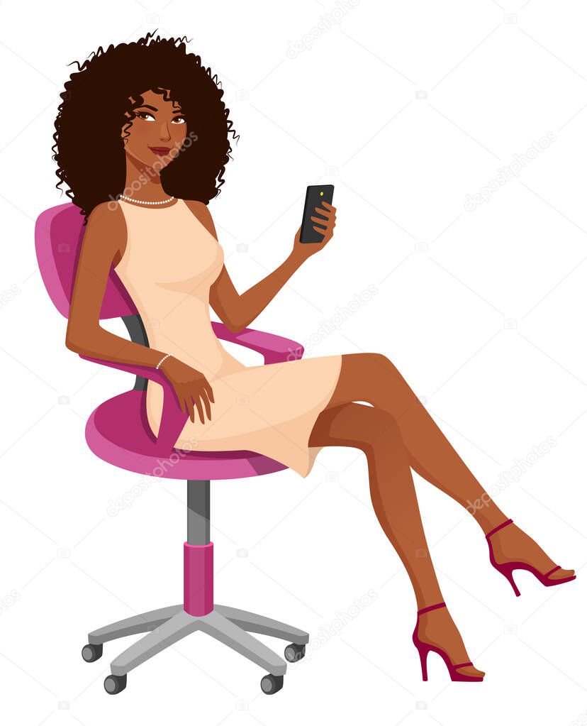 beautiful African American businesswoman sitting in an office chair, holding a cell phone.