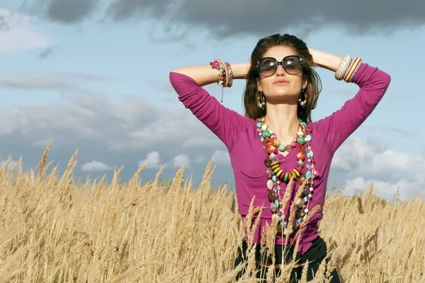 Young woman wearing jewellery and sunglasses — Stock Photo, Image