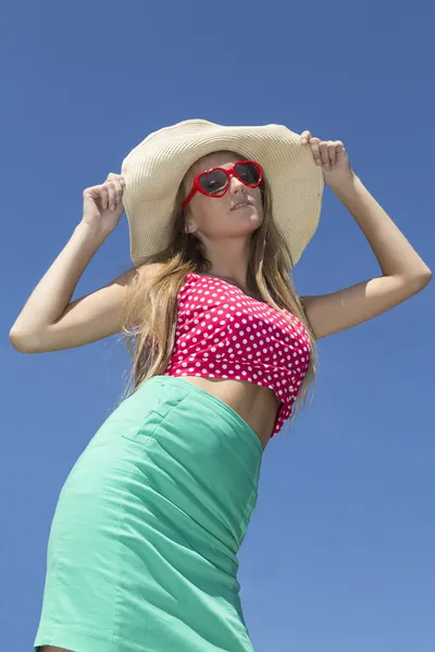 Beautiful blonde holding hat by two hands — Stock Photo, Image