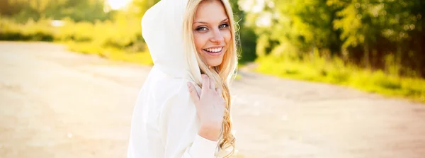 Roztomilá usmívající se dívka venkovní v parku při pohledu na vás — Stock fotografie
