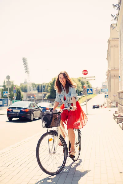 Beautiful woman in dress with bike — Stock Photo, Image