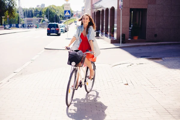 Beautiful woman in dress with bike — Stock Photo, Image