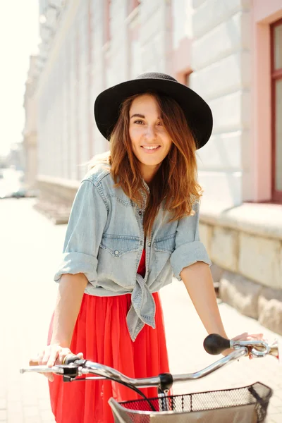 Beautiful woman in dress with bike — Stock Photo, Image