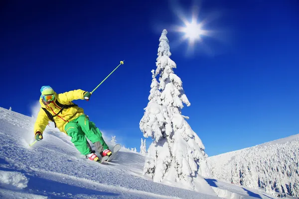 Skier skiing downhill in high mountains — Stock Photo, Image