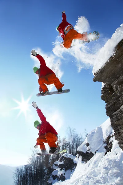 Snowboarder springt gegen blauen Himmel — Stockfoto