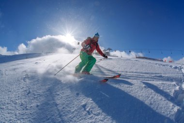 yokuş aşağı güneşli gün boyunca yüksek dağlarda kayak kayakçı