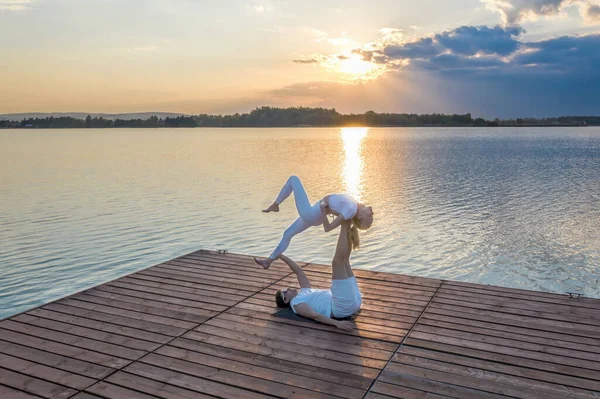 Beautiful Young Couple Doing Acro Yoga Pier Sunset Man Lying — Stock Photo, Image