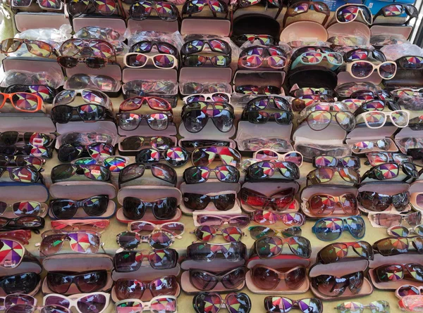 Colourful umbrella reflected in sunglasses on street market. Yangon. Myanmar. — Stock Photo, Image