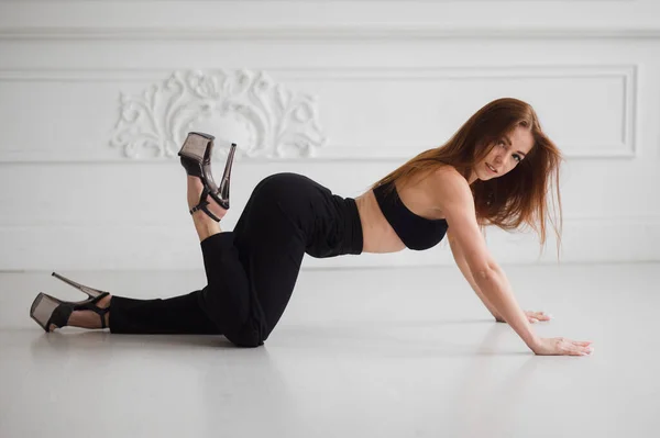 Happy young woman dancing alone having fun at home listening to good music, energetic girl moving jumping in modern living room interior — Stock Photo, Image