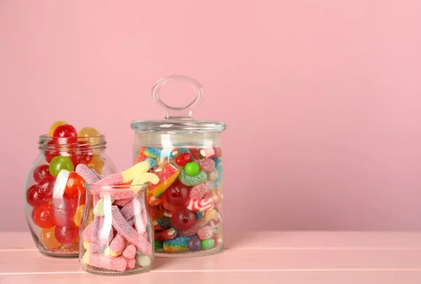 Jars Different Delicious Candies Pink Wooden Table Space Text — Stock Photo, Image