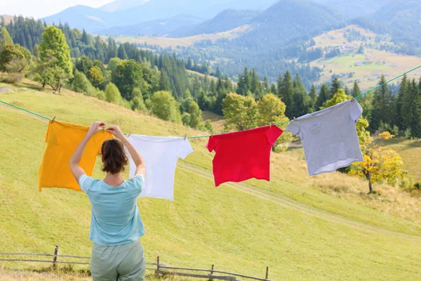 Woman Hanging Clean Laundry Clothespins Washing Line Mountains Back View — Stock Photo, Image