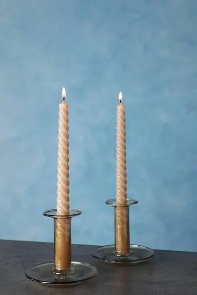 Holders Burning Candles Black Table Light Blue Wall — Stock Photo, Image