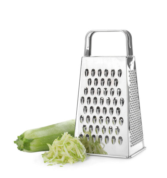 Stainless steel grater and fresh squash on white background