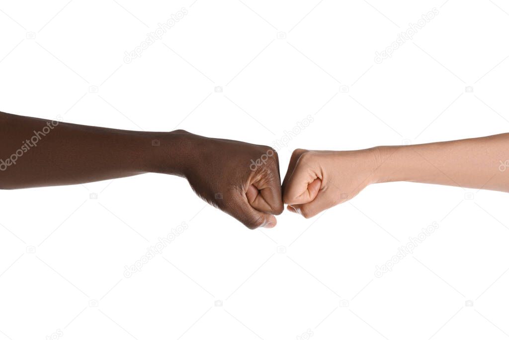 Woman and African American man making fist bump on white background, closeup