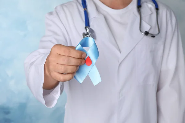 Lekarz Trzymający Jasnoniebieską Wstążkę Papierową Kroplą Krwi Jako Symbol Świadomości — Zdjęcie stockowe