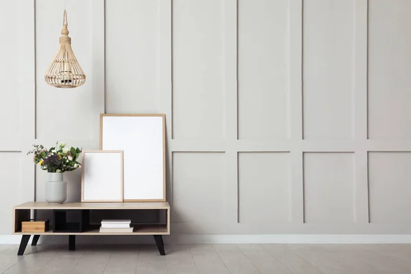 Simple room interior with console table, decor elements and empty wall. Space for design