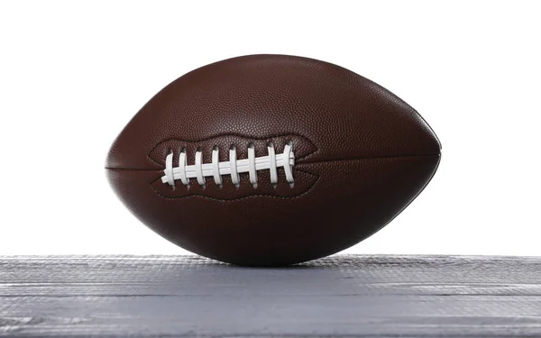 白い背景を持つ灰色の木製のテーブルの上にアメリカのサッカーボール — ストック写真