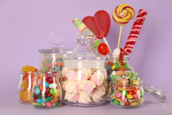 Jars Different Delicious Candies Violet Background — Stock Photo, Image