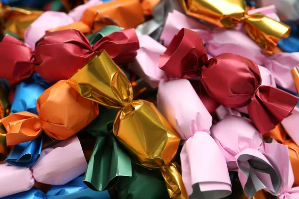 Many candies in colorful wrappers as background, closeup