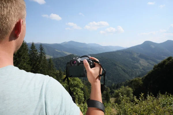 山の中で近代的なカメラを持つプロの写真家 クローズアップ — ストック写真