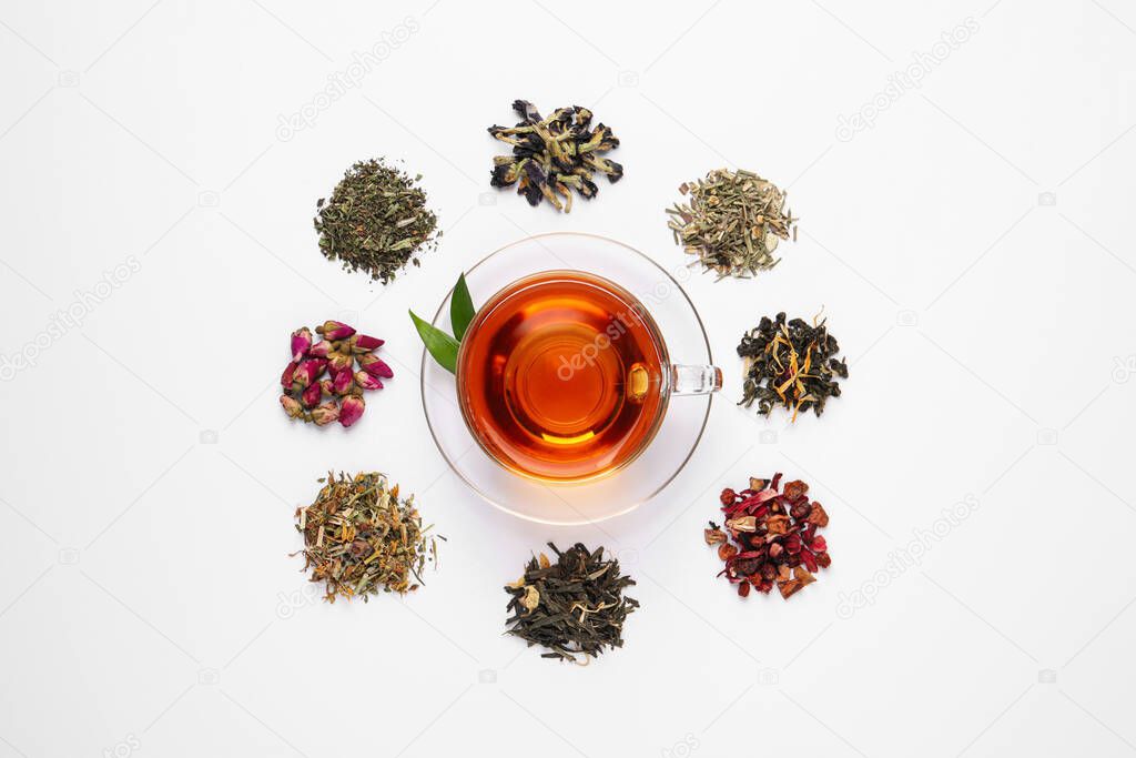 Composition with brewed tea, dry and fresh leaves on white background, top view