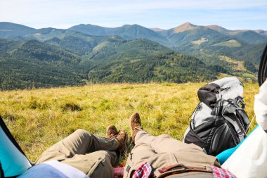 Dağlardaki kamp çadırında dinlenen çift, yakın plan.