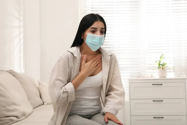 Young Woman Protective Mask Suffering Breathing Problem Sofa Home — Stock Photo, Image