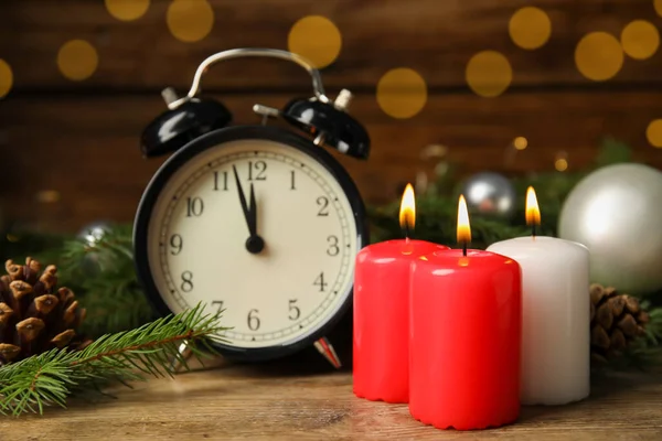 Alarm Clock Burning Candles Christmas Decor Wooden Table Bokeh Effect — Stock Photo, Image