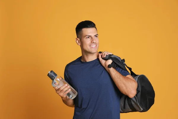 Handsome Man Sports Bag Bottle Water Yellow Background — Stock Photo, Image