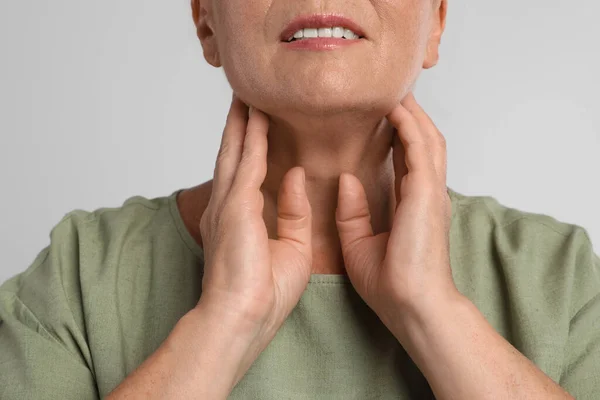 Mature Woman Doing Thyroid Self Examination Light Grey Background Closeup — Stock Photo, Image