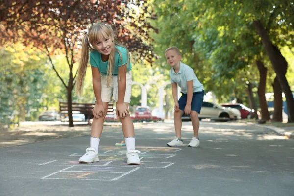 Malé Děti Hrají Hopscotch Nakreslený Křídou Asfaltu Venku — Stock fotografie