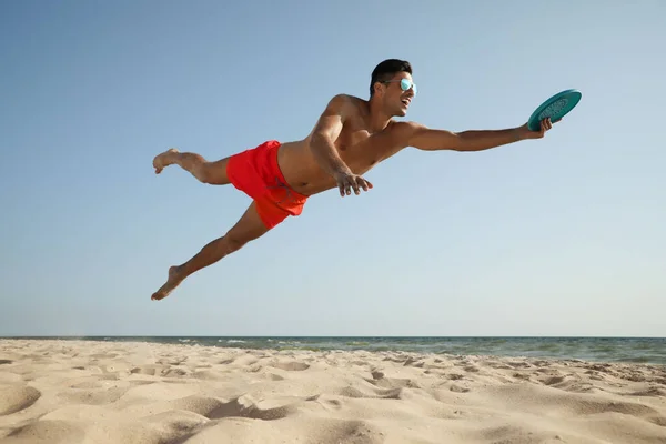 Спортивний Чоловік Стрибає Ловить Літаючий Диск Пляжі — стокове фото