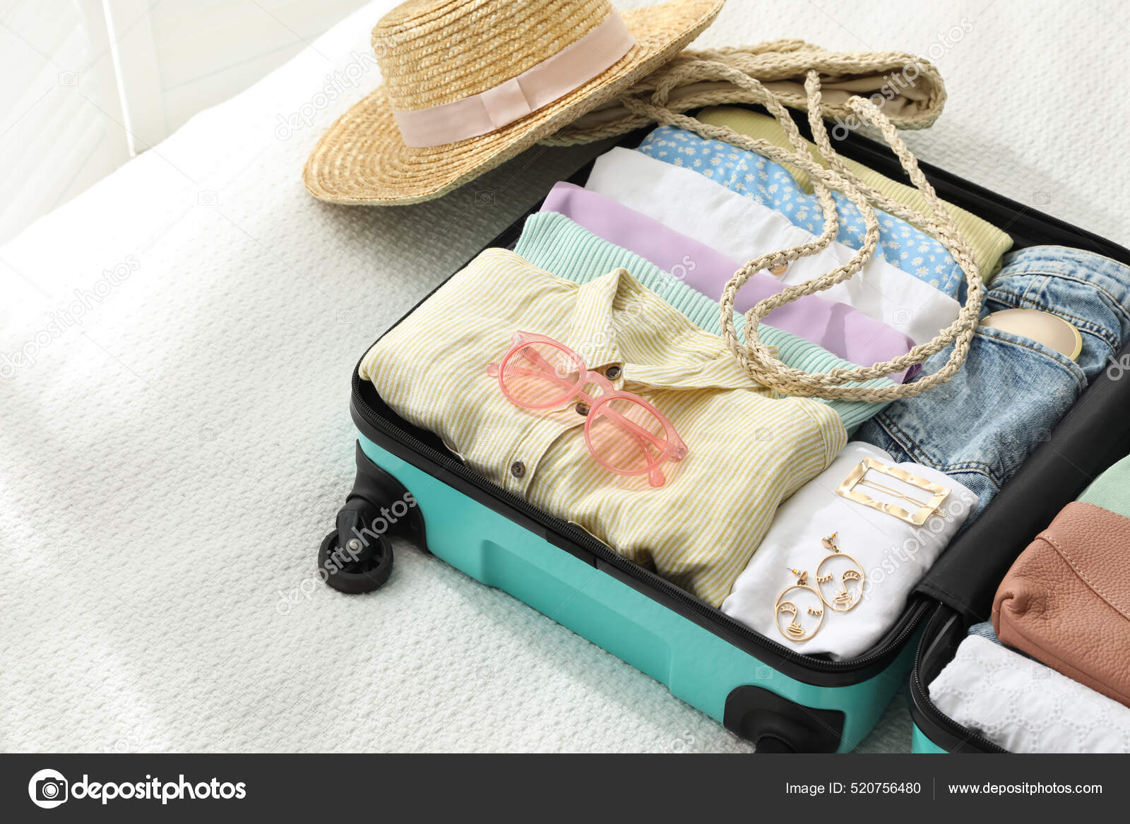 https://st.depositphotos.com/16122460/52075/i/1600/depositphotos_520756480-stock-photo-open-suitcase-packed-trip-accessories.jpg