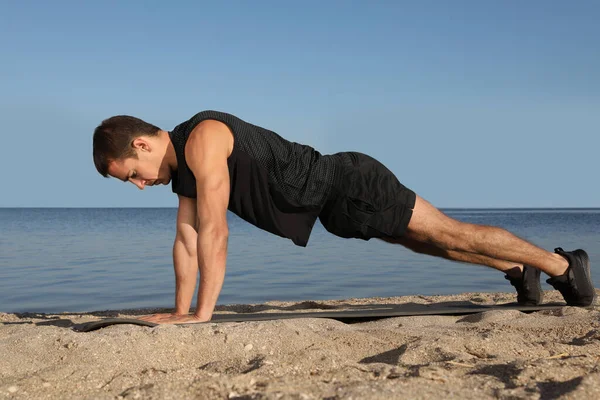 Sportowy Człowiek Robi Proste Ramię Deski Ćwiczenia Plaży — Zdjęcie stockowe