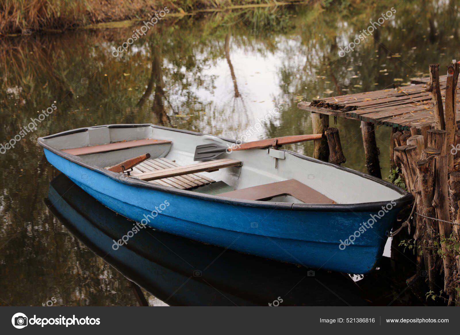 Light Blue Wooden Boat Oars Lake Pier Stock Photo by ©NewAfrica 521386816