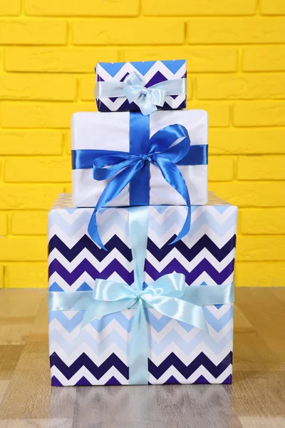 Three Gift Boxes Yellow Brick Wall — Stock Photo, Image